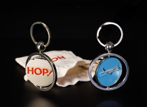 Porte-clé rotatif avec un décor 3D sur le recto et un logo émaillée sur le verso